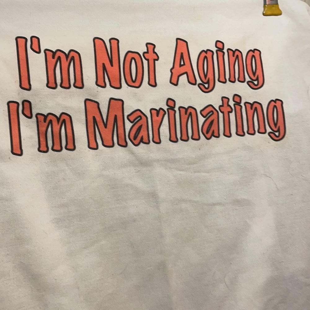 Apron is cotton tie waist and hoop around neck I’m not aging I’m marinating